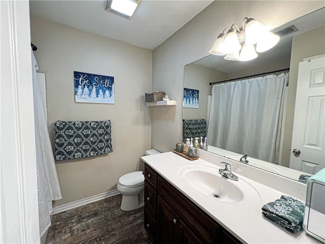 bathroom featuring hardwood / wood-style flooring, vanity, and toilet