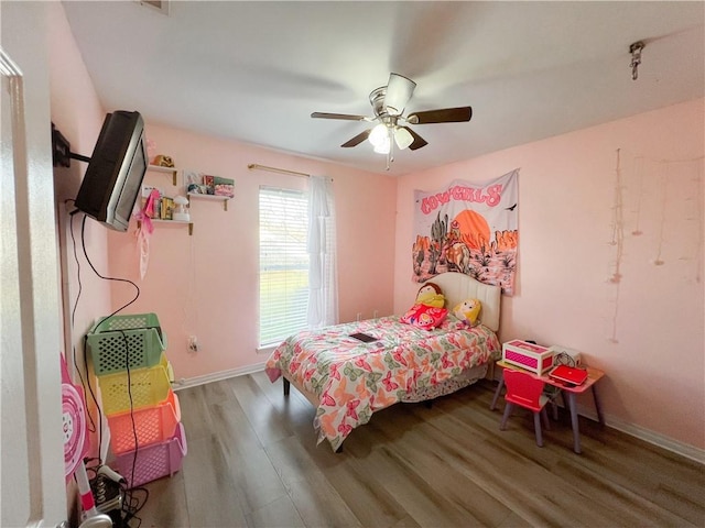 bedroom with hardwood / wood-style floors and ceiling fan