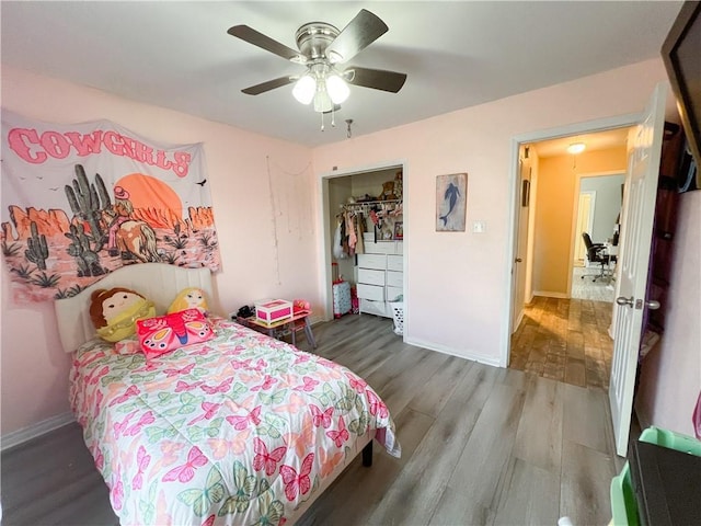 bedroom featuring ceiling fan, wood-type flooring, and a closet