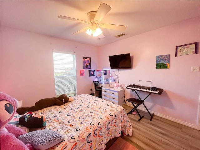 bedroom with hardwood / wood-style flooring and ceiling fan