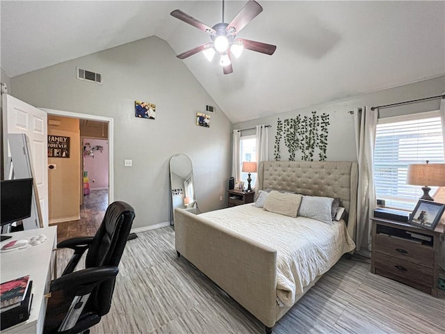 bedroom with ceiling fan, high vaulted ceiling, and light hardwood / wood-style flooring