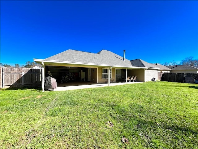 back of house with a yard and a patio area