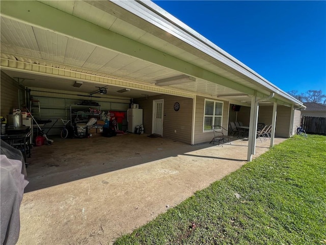 back of property featuring a carport and a lawn