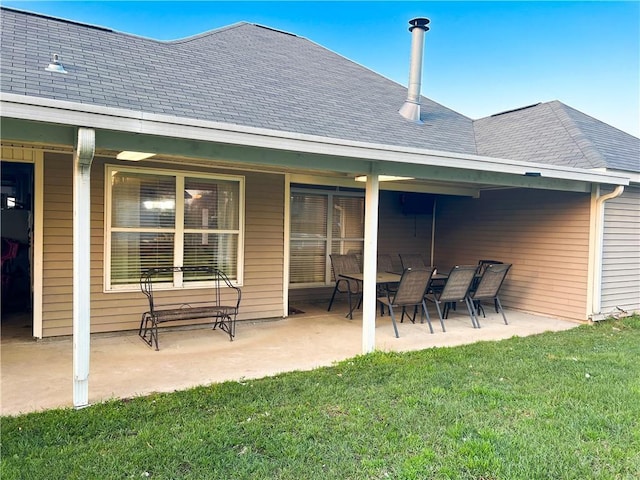 rear view of house with a lawn and a patio area