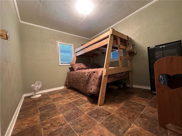 bedroom with ornamental molding and a textured ceiling