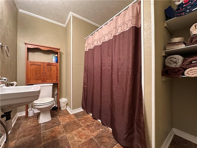 bathroom featuring ornamental molding, toilet, curtained shower, and a textured ceiling