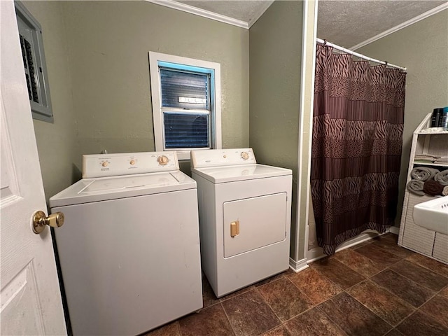 washroom featuring crown molding, separate washer and dryer, electric panel, and a textured ceiling