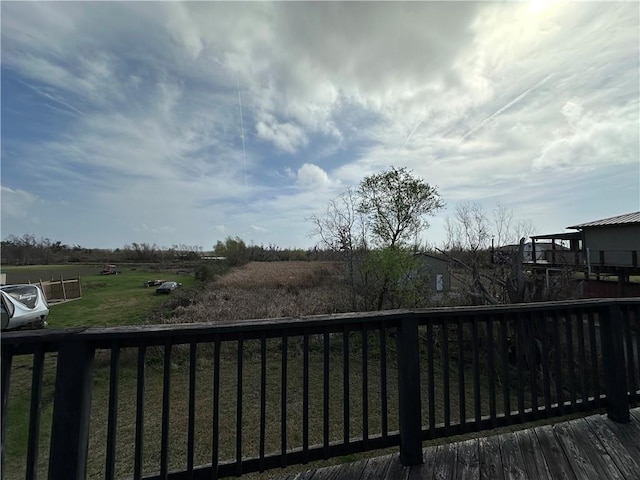 wooden deck with a rural view