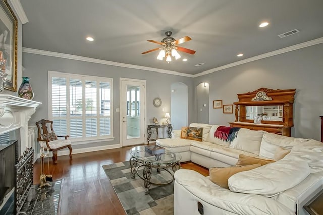 living room with crown molding, hardwood / wood-style floors, and ceiling fan