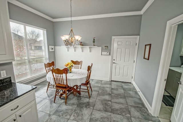 tiled dining space with ornamental molding and a chandelier