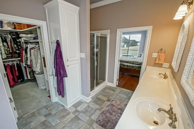 bathroom with walk in shower and vanity