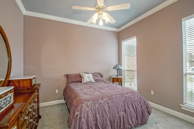 bedroom featuring crown molding, light colored carpet, and ceiling fan