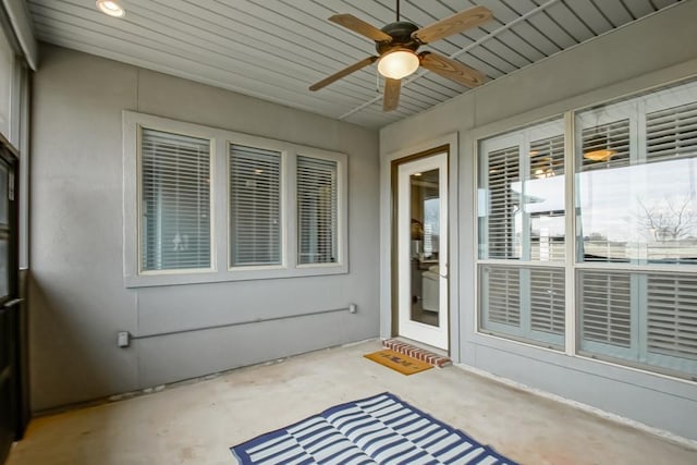 entrance to property with a patio area and ceiling fan