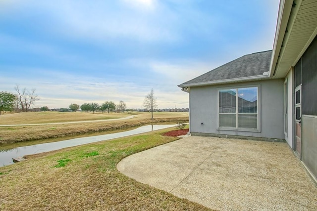 view of yard featuring a patio and a water view