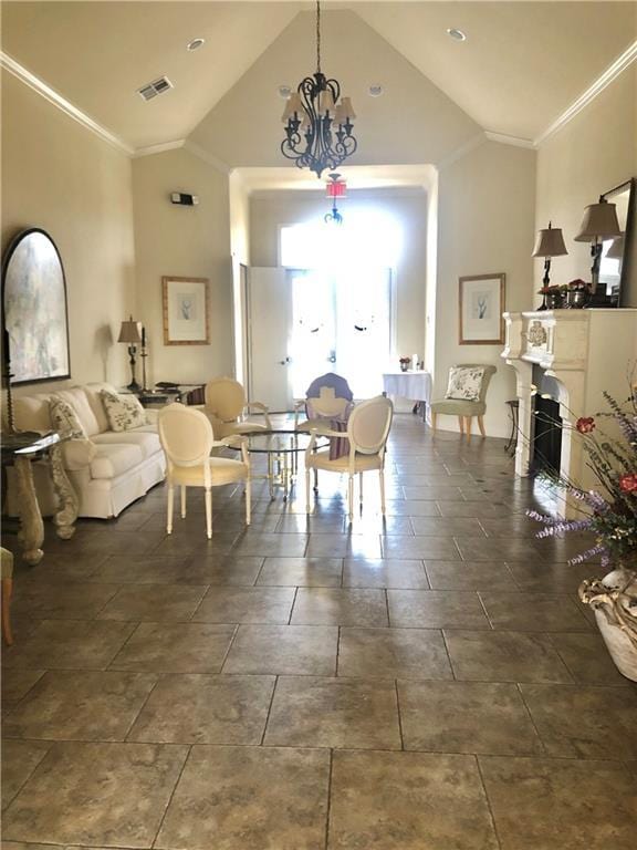 living room with an inviting chandelier, crown molding, and high vaulted ceiling