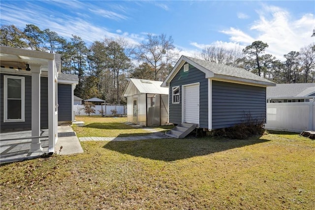 view of yard featuring entry steps, a storage shed, a fenced backyard, and an outdoor structure