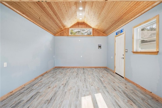 unfurnished room featuring a healthy amount of sunlight, wooden ceiling, vaulted ceiling, and wood finished floors