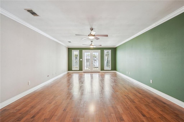 unfurnished room featuring ornamental molding, french doors, baseboards, and wood finished floors