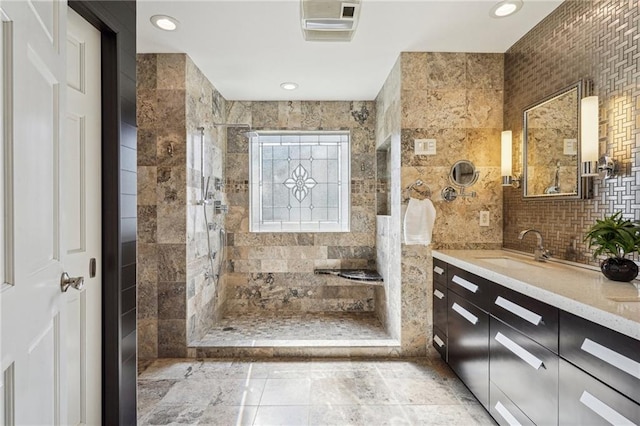 full bathroom with decorative backsplash, a walk in shower, tile walls, and vanity