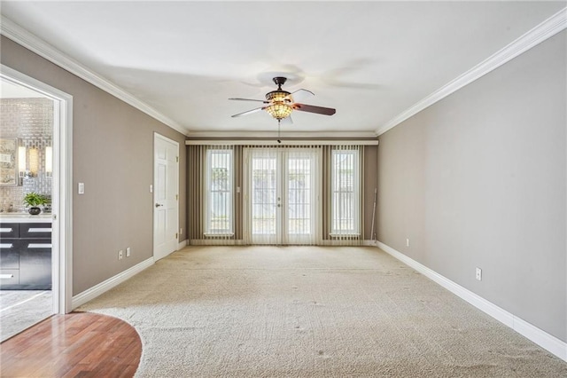 interior space featuring baseboards, ornamental molding, and light colored carpet