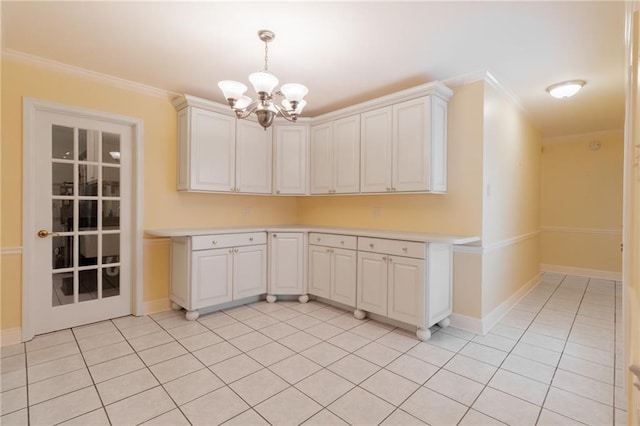 kitchen featuring white cabinetry, ornamental molding, and hanging light fixtures