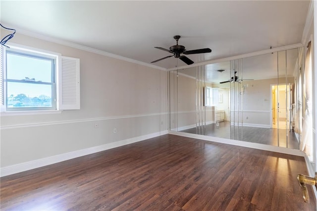 spare room featuring crown molding, ceiling fan, and dark hardwood / wood-style flooring