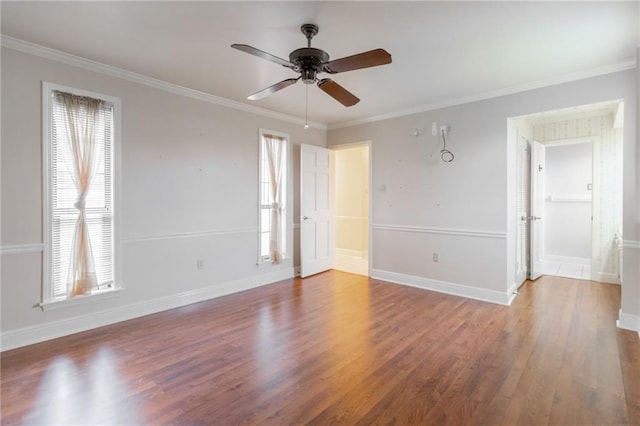 spare room featuring wood-type flooring, ceiling fan, and crown molding