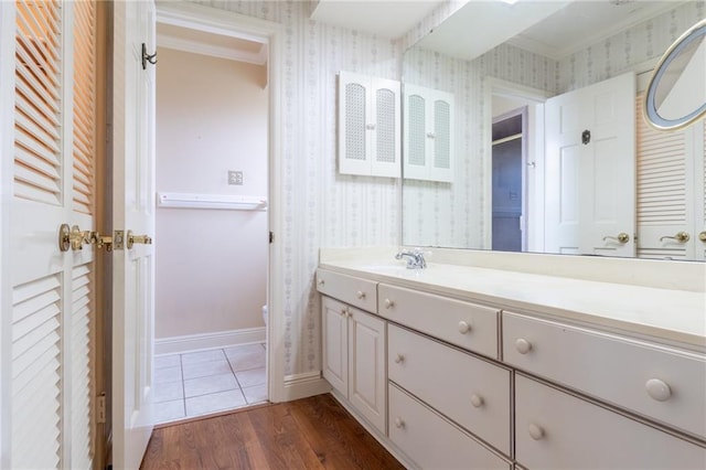 bathroom featuring vanity, hardwood / wood-style flooring, crown molding, and toilet