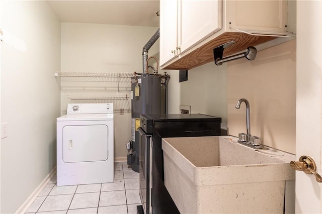 clothes washing area with sink, light tile patterned floors, cabinets, gas water heater, and washer / clothes dryer