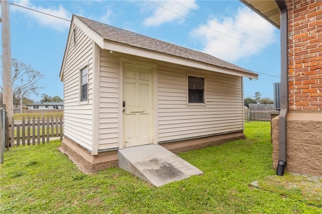 view of outbuilding featuring a lawn