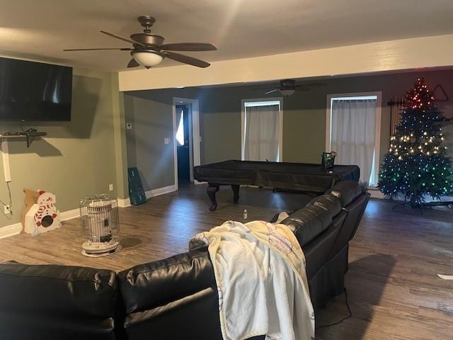 living room featuring dark wood-type flooring, ceiling fan, and pool table