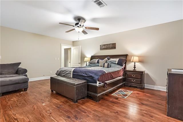 bedroom with ceiling fan and dark hardwood / wood-style flooring