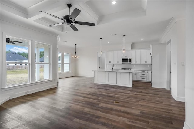 kitchen featuring a center island with sink, white cabinets, dark hardwood / wood-style flooring, and decorative light fixtures