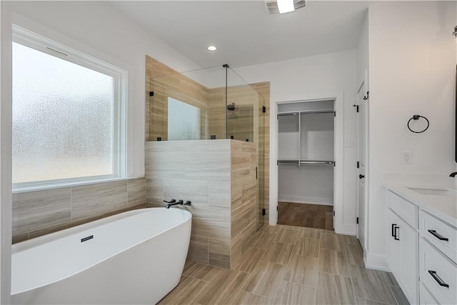 bathroom with plus walk in shower and vanity