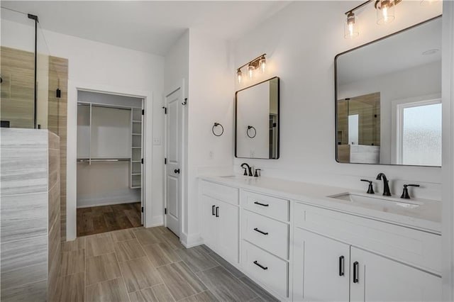 bathroom featuring vanity and an enclosed shower