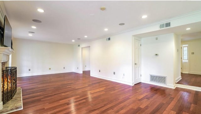 unfurnished living room with crown molding and dark hardwood / wood-style floors