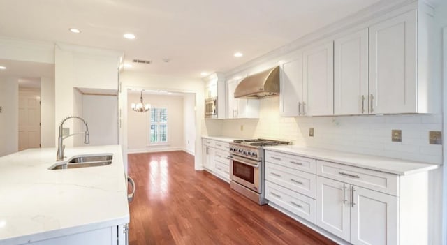 kitchen featuring stainless steel appliances, range hood, sink, and white cabinets