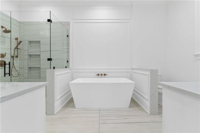 bathroom with vanity and shower with separate bathtub