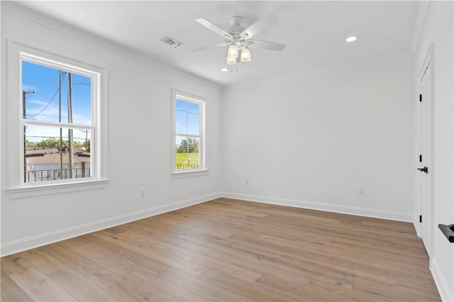 unfurnished room with crown molding, light hardwood / wood-style floors, and ceiling fan