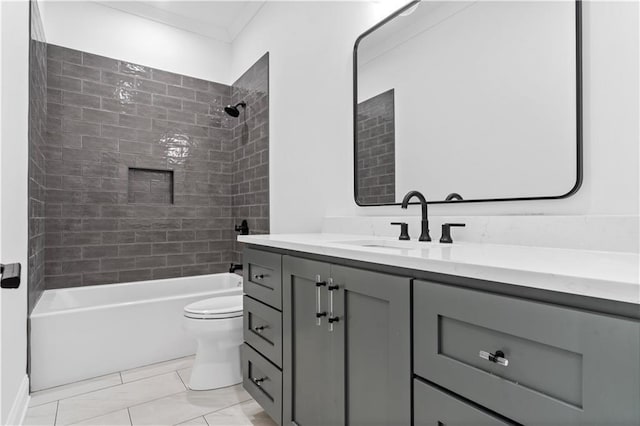 full bathroom featuring vanity, tiled shower / bath, ornamental molding, and toilet