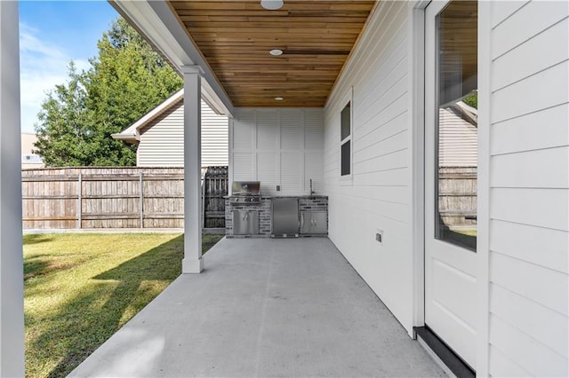 view of patio with an outdoor kitchen and a grill