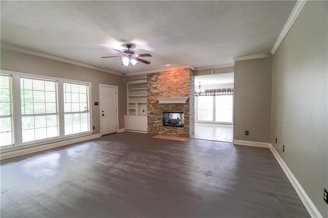 unfurnished living room featuring crown molding, built in shelves, ceiling fan with notable chandelier, and a textured ceiling