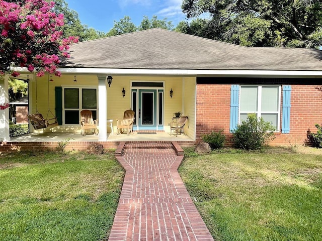 view of front of property featuring a patio area and a front lawn