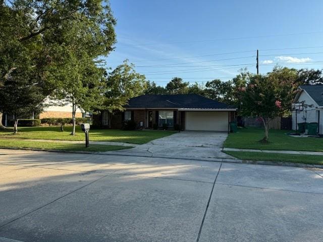 single story home with a garage and a front lawn