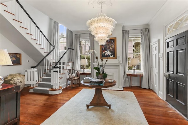 foyer entrance with hardwood / wood-style flooring and a chandelier