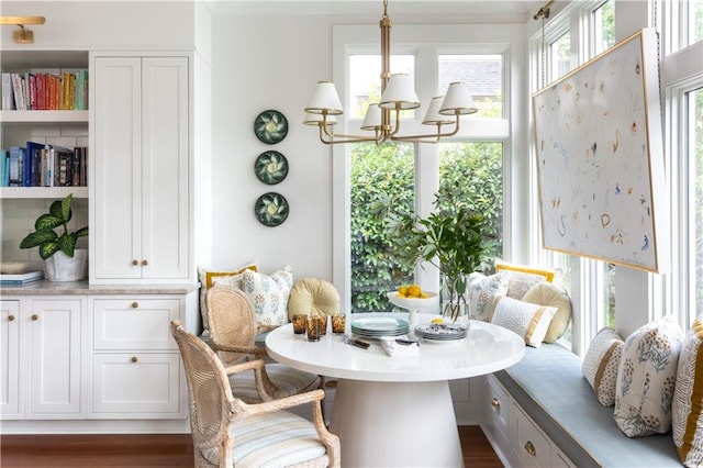 dining room with breakfast area, a chandelier, and dark wood-type flooring