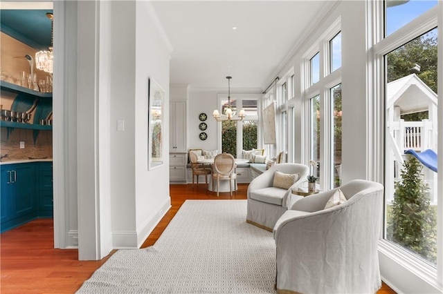 sunroom featuring a chandelier