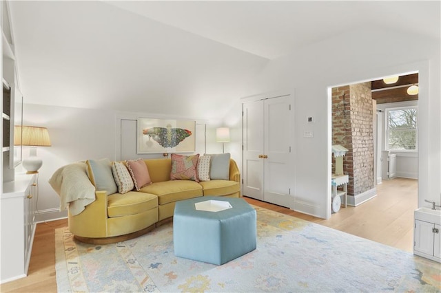 living room with lofted ceiling and light wood-type flooring