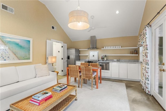 living room featuring sink and high vaulted ceiling