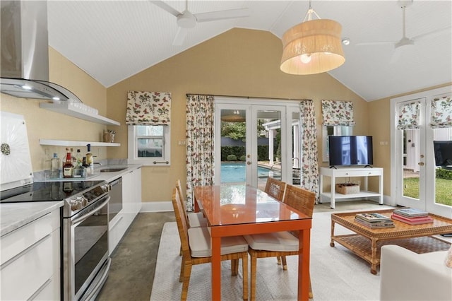 kitchen featuring french doors, lofted ceiling, white cabinetry, ventilation hood, and stainless steel electric range